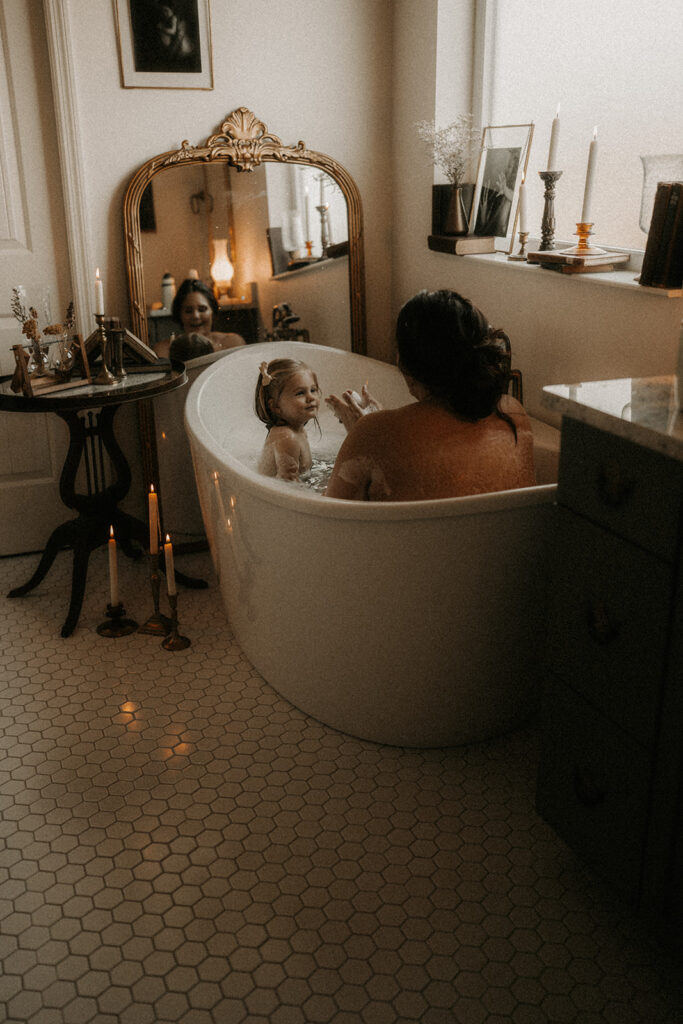 a mother and daughter playing in the bath posing for a mother and daughter photoshoot | nostalgic motherhood photoshoot
