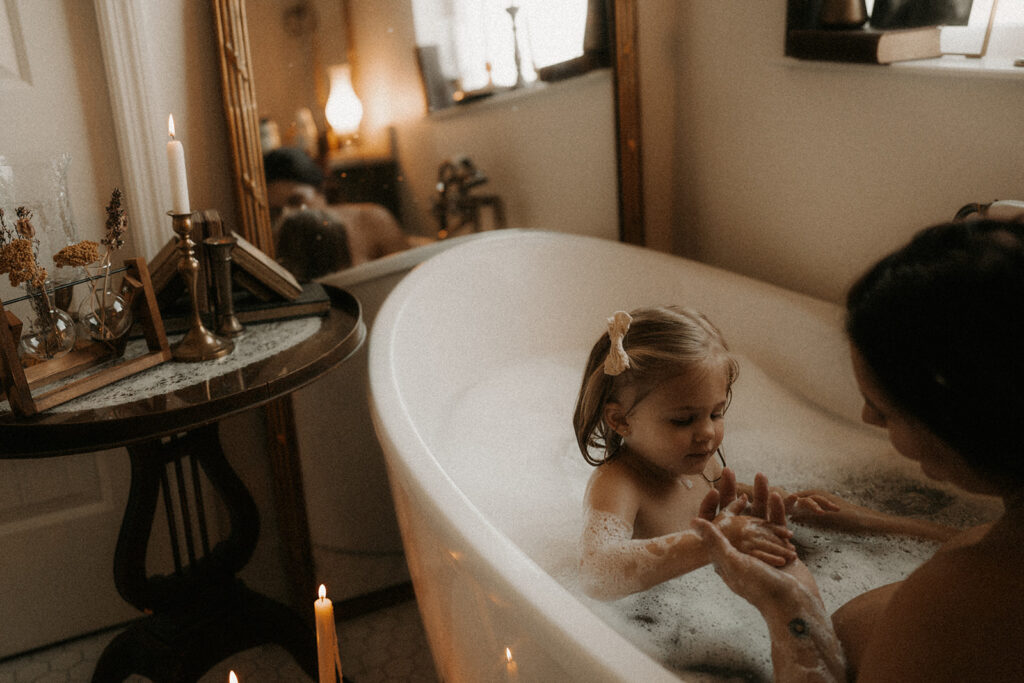 a mother and daughter playing in the bath posing for a mother and daughter photoshoot | nostalgic motherhood photoshoot
