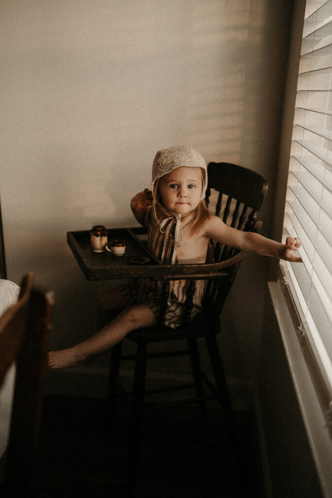 little girl sitting in a high chair